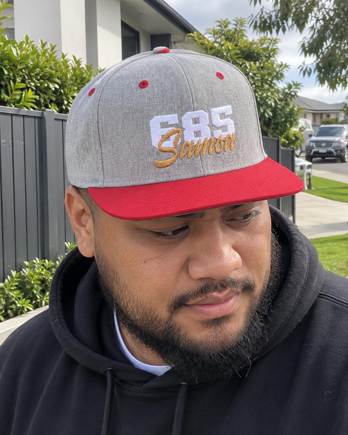 Flat Bill Snapback Hat in the 685 Samoa print, worn outdoors on an ordinary day.