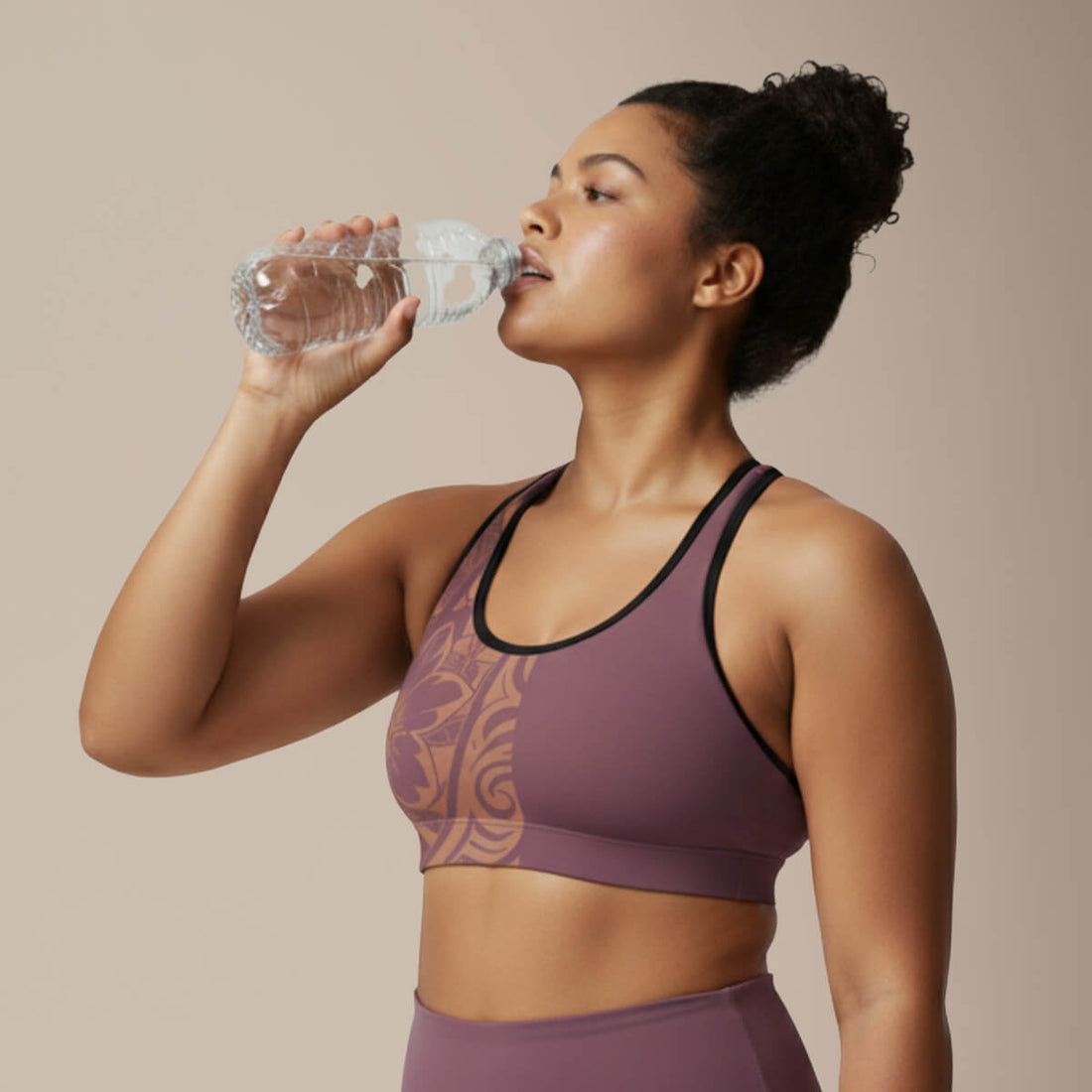 Black seamless sports bra with white stitching from Miami Sublimation, paired with IslandRise high-waisted leggings in Brandied Melon.