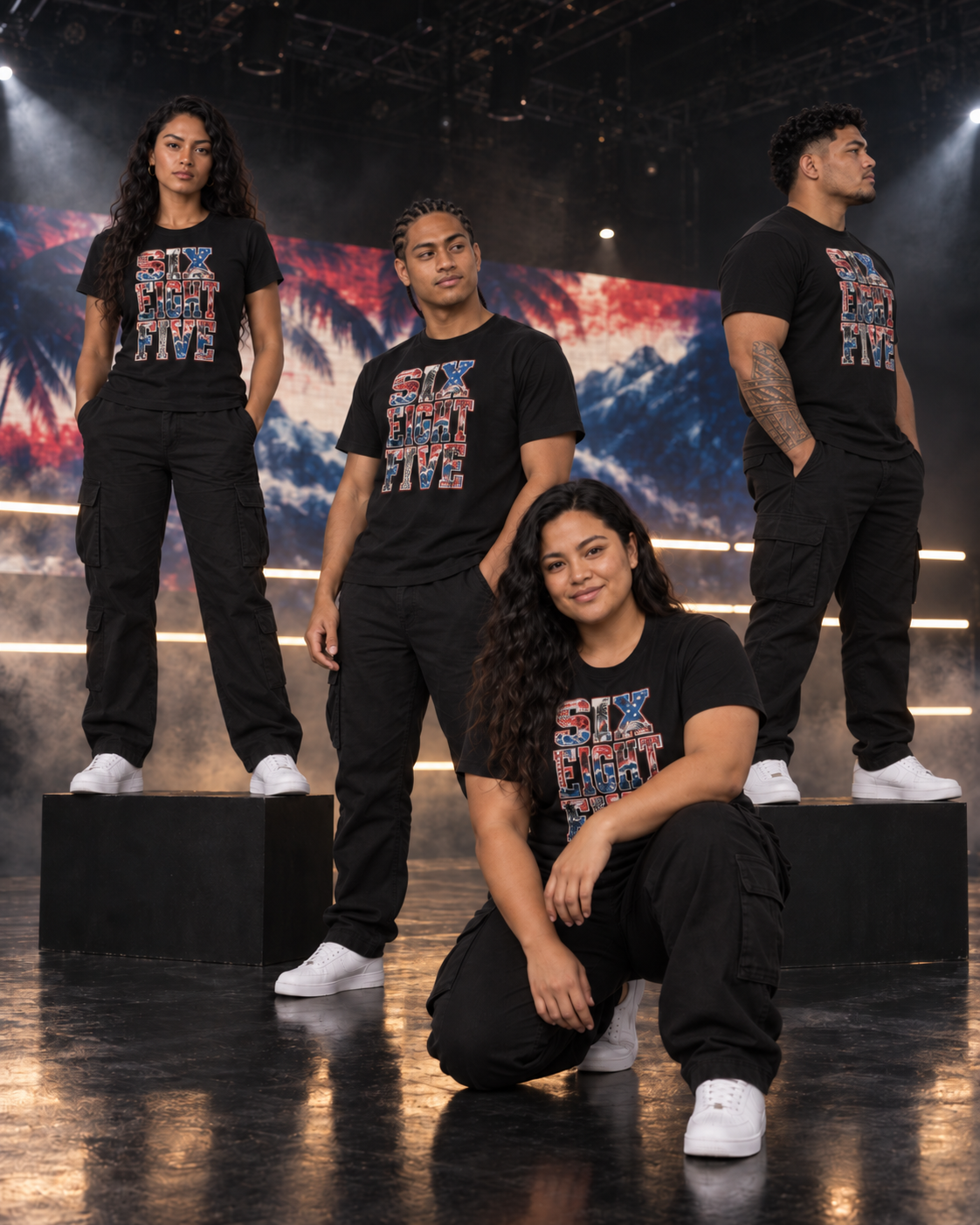 Four friends in the 685 Samoa tee on a dark soundstage, ocean and palms on the screen behind them