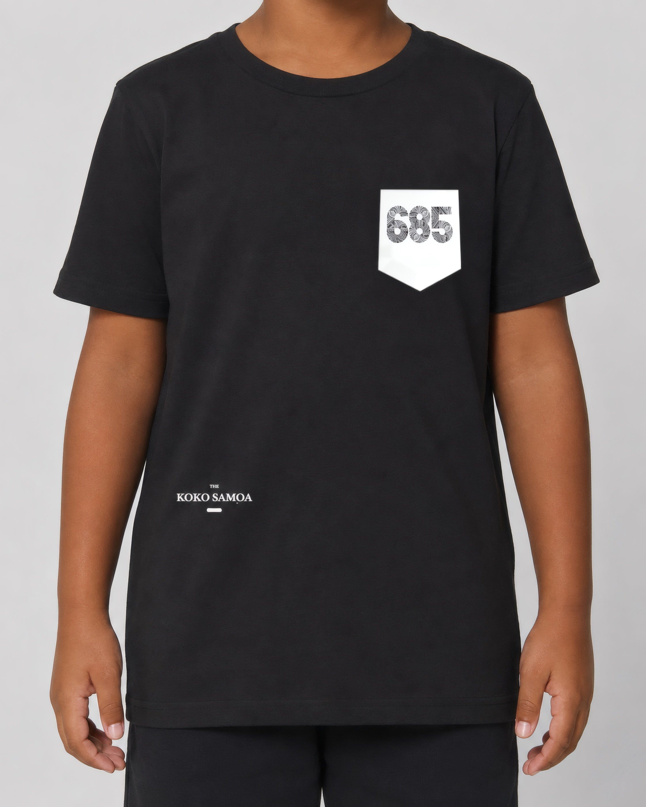 Kids Tee - 685 Pocket on a light grey studio background