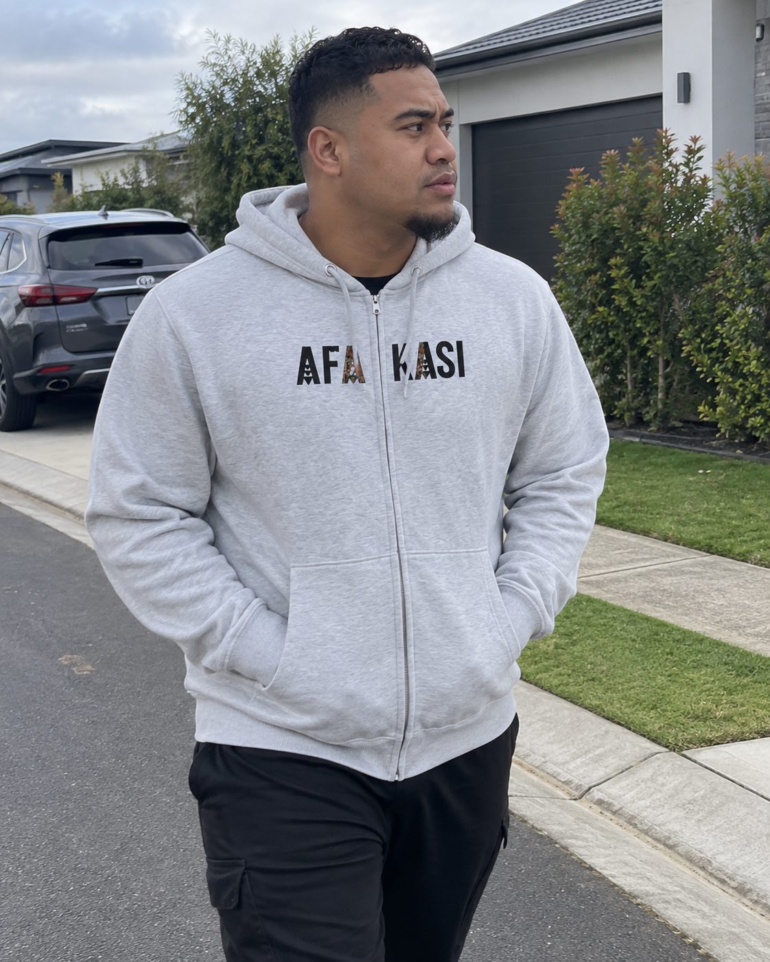 Unisex Zip Hoodie in the AFAKASI print, worn out on an ordinary day.
