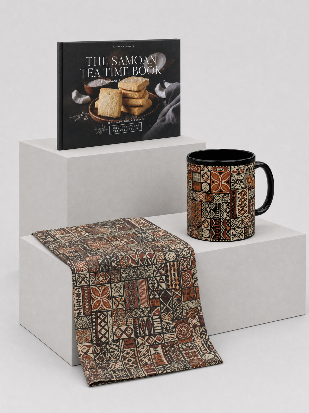 The Tea Time Gift Set: Recipe Keepsake - 6 Samoan Tea Time Bakes, Mug 11oz - Elei and Microfiber Tea Towel - Elei, shown together.